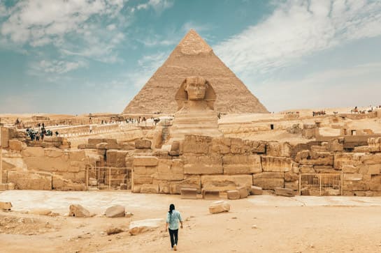 A tourist exploring Egyptian pyramids on a North African river cruise excursion